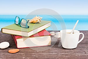 Tropical sea seen from the boat. Book and  coffee on table. Reading and relaxing on vacation