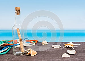 Tropical sea seen from the boat. Message in bottle on table