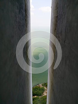 Tropical sea seen from between tall concrete walls