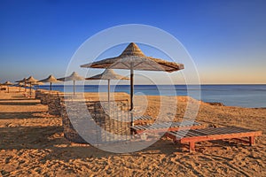 Tropical sea shore with sun umbrellas.