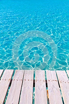 Tropical sea water texture from a wooden pier