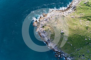 Tropical sea with wave crashing on seashore and high mountain located at Laem krating viewpoint new landmark in Phuket Thailand