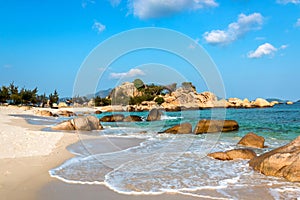 Tropical Seascape with White Sandy Beach, Waves, Rocks, Clouds and Sky