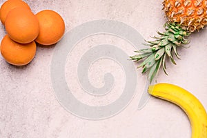 Tropical and Seasonal Summer Fruits. Pineapple Oranges and Bananas Arranged in corner of backgrounds, Healthy Lifestyle.