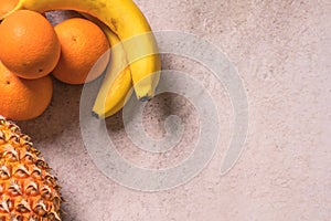 Tropical and Seasonal Summer Fruits. Pineapple Oranges and Bananas Arranged in corner of backgrounds, Healthy Lifestyle