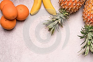 Tropical and Seasonal Summer Fruits. Pineapple Oranges and Bananas Arranged in upper of backgrounds, Healthy Lifestyle.