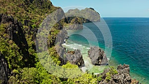 Tropical seawater lagoon and beach, Philippines, El Nido. Tropical island with rocky shore and white beach.Tourist