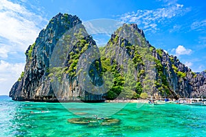 Tropical Shimizu Island and paradise beach, El Nido, Palawan, Philippines. Tour A Route. Coral reef and sharp limestone cliffs