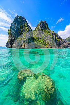 Tropical Shimizu Island and paradise beach, El Nido, Palawan, Philippines. Tour A Route. Coral reef and sharp limestone cliffs