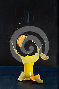 Tropical splash in a glass of citrus on a dark background