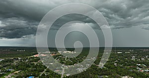 Tropical storm in Florida. Stormy clouds forming during heavy thunderstorm on dark sky. Moving and changing cloudscape