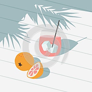 Tropical summer greeting card, invitation. Cocktail drink with ice, grapefruit, orange fruit. White table backgound in