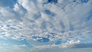 Tropical summer sunlight and sunrays. Colorful cumulus and cirrocumulus on different layers clouds in the sky after