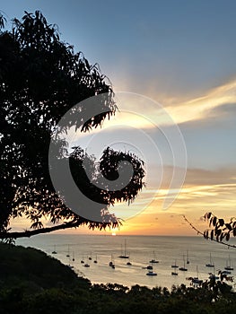 The tropical sun sinking below the horizon as seen at Admiralty Bay, Bequia