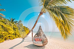 Tropical sunset beach background as summer landscape panorama with beach swing or hammock and white sand and calm sea beach