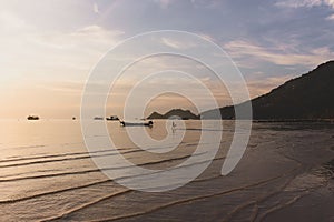 Tropical sunset in the beach with kid running