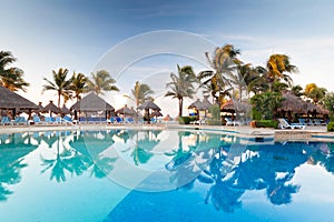 Tropical swimming pool at sunrise