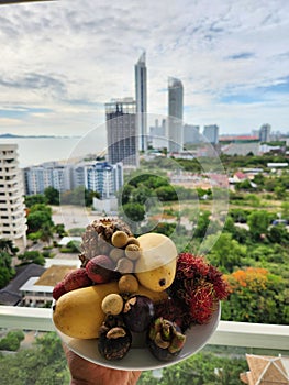 Tropical thai fruits with a view of Jomtien beach, Pattaya Thailand