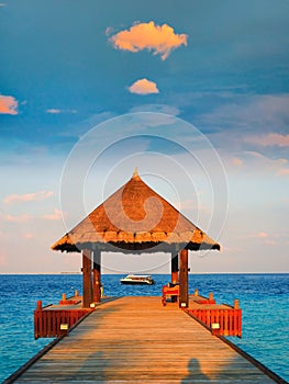 Tropical thatched roof Pavilion sunset, Maldives