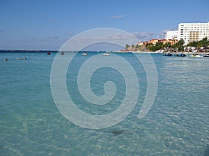 Tropical view of white hotels buildings on sandy beach at bay of Caribbean Sea in Cancun city in Mexico