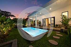 Tropical villa view with garden and swimming pool