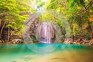 Tropical waterfall with emerald lake in jungle forest