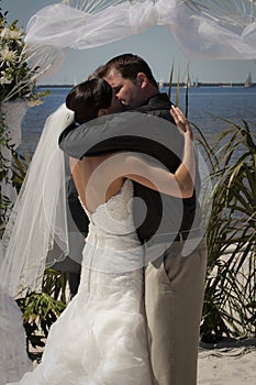 Tropical wedding couple kiss