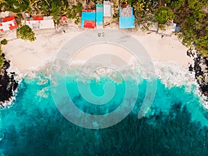 Tropical white sand beach with coconut palms and turquoise ocean. Aerial view