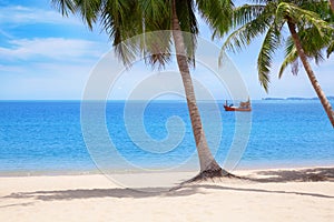 Tropical white sand beach landscape, turquoise sea water, blue sky, clouds, green palm tree leaves, boat, sunny day, nobody, relax