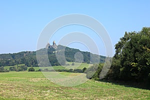 Trosky Castle behind meadows and forest