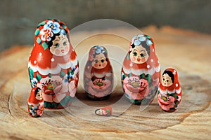Trouble in matryoshka family. Russian doll on a wooden table.