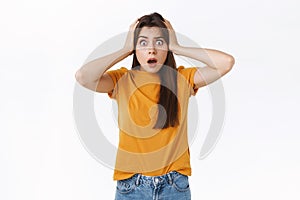 Troubled, alarmed young woman panicking, feeling uneasy or embarrassed, open mouth gasping, nervously stare camera, hold