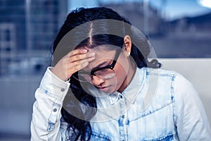 Troubled Asian woman with hand on face