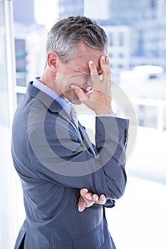 Troubled businessman holding his head