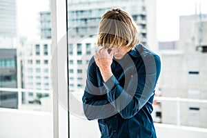 Troubled hipster businessman holding his head