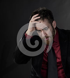 Troubled Man in Black and Maroon Formal Wear