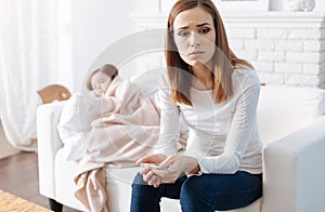 Troubled mother taking care of her sick daughter