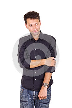 Troubled sad man standing lonely with hand on elbow