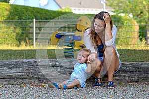 Troubled stressed young mother with her baby son