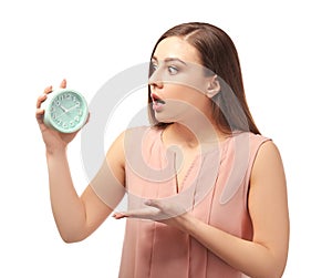 Troubled woman with alarm clock on white background. Time management concept