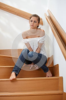 Troubled woman at staircase