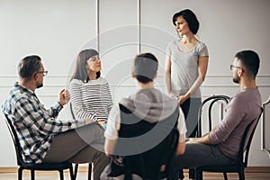 Women listening to pshychologist during support group meeting