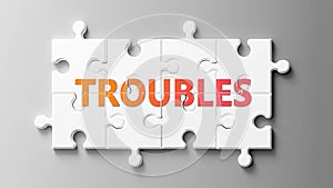 Troubles complex like a puzzle - pictured as word Troubles on a puzzle pieces to show that Troubles can be difficult and needs