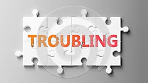 Troubling complex like a puzzle - pictured as word Troubling on a puzzle pieces to show that Troubling can be difficult and needs