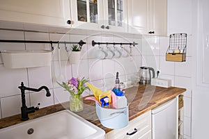 trough with hygiene cleaning items, spring home cleaning, wipes, detergents, hyacinth flowers in vase on table, spring home