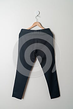 Trousers or long pants hanging on wall