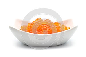 Trout eggs in a white ceramic bowl on white background