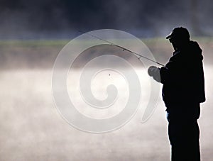 Trout Fisherman by a Misty Lake