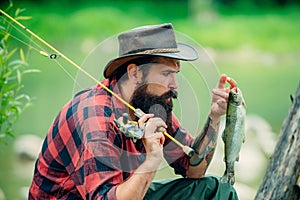 Trout on a hook. Fly fishing - method for catching trout. Fishing with spinning reel. Catches a fish. Fishing in river