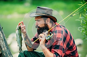 Trout on a hook. Fly fishing - method for catching trout. Fishing with spinning reel. Catches a fish. Fishing in river